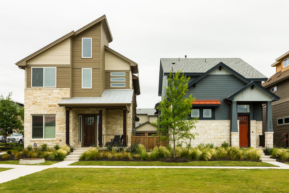 Two homes sit side by side. The left house has a unique modern slanted roof architecture and is tan. The right is green and a modern take on a traditional cottage.